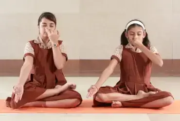 two girl students from MVM school doing yoga